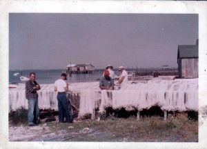 A picture of fishermen mending nets at the Landing on Harkers Island in the 1960s.