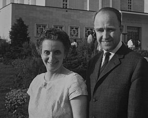 A couple stands in front of the temple